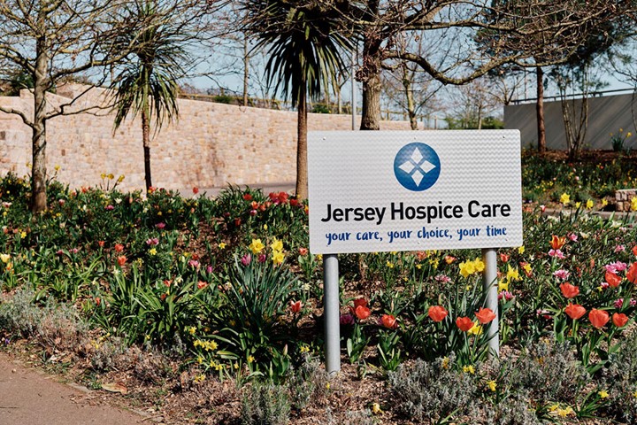 Image of Jersey Hospice Care sign surrounded by flowers