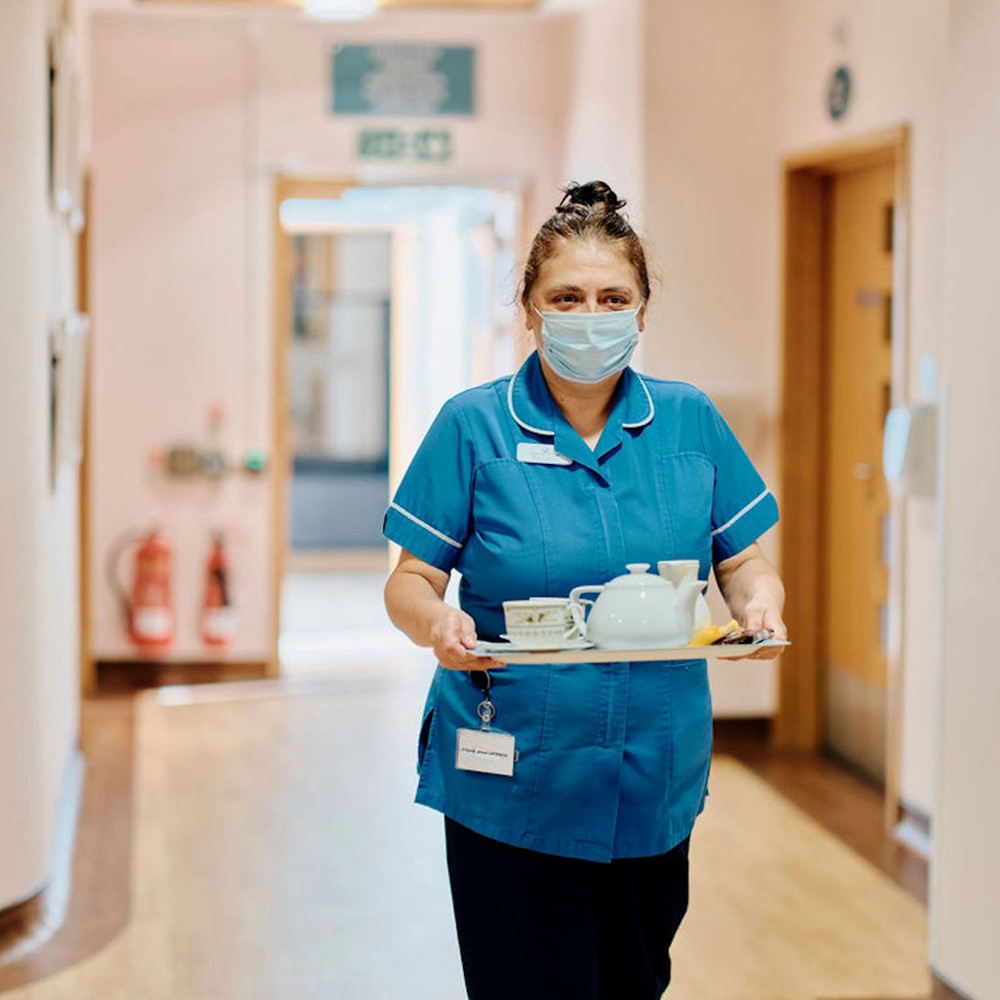 Image of Health Care Assistant carrying tea tray 
