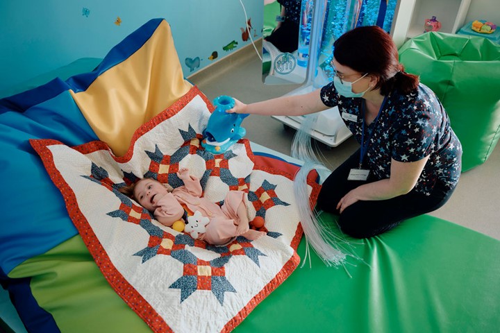 Image of baby and nurse in sensory room 