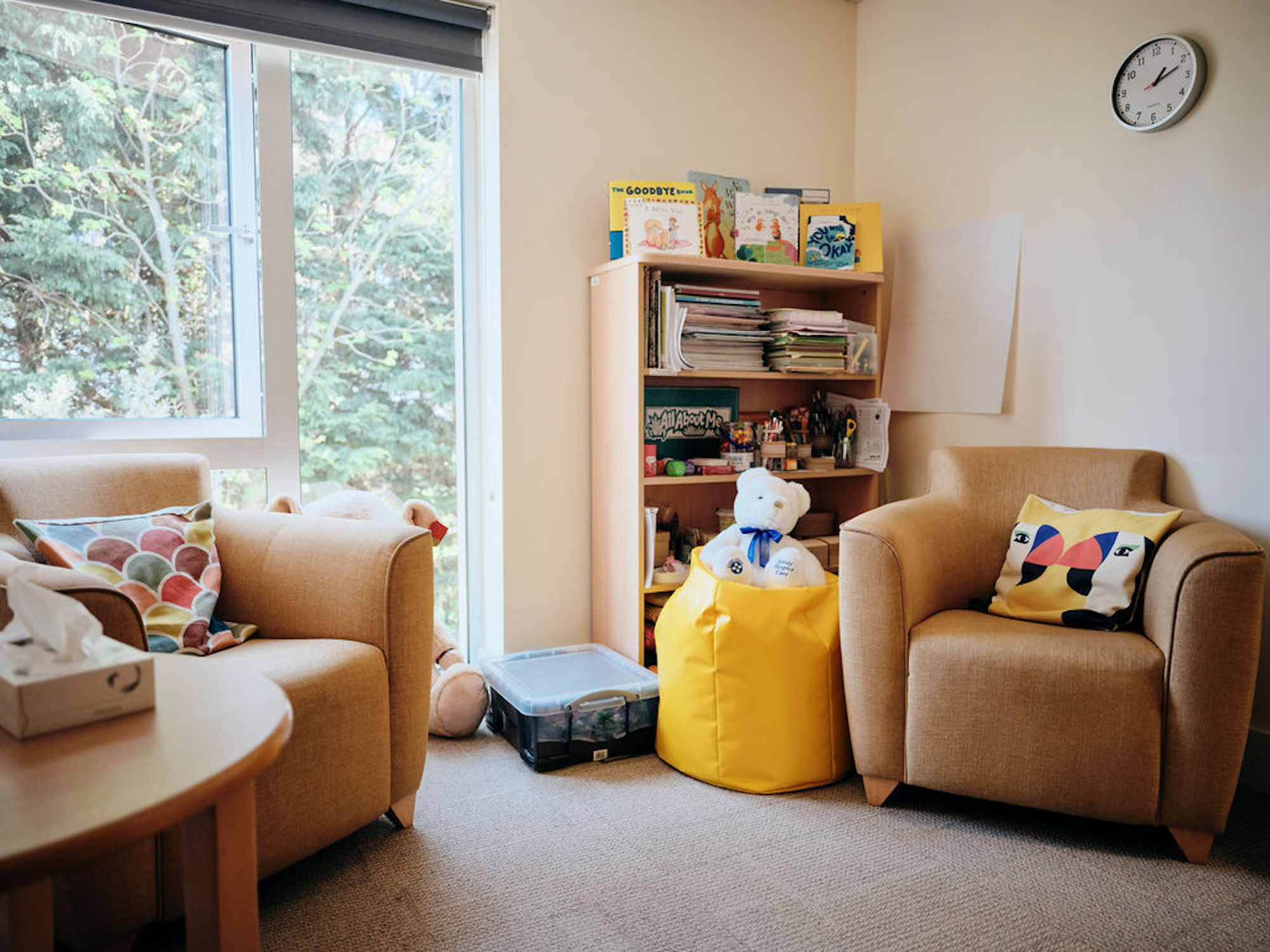 Image of bereavement room - two chairs, table and bookshelf in corner
