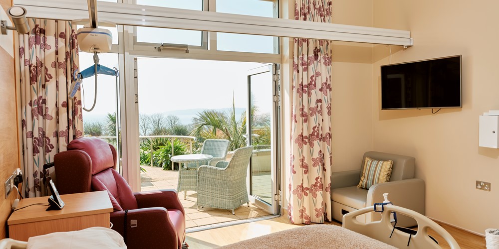Image of an In Patient Unit room at Jersey Hospice Care with balcony doors open