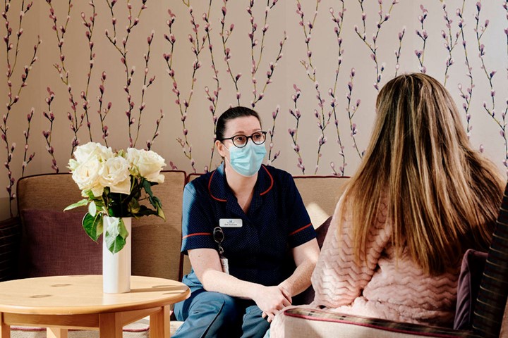 Image of nurse talking. to patient in family room at Jersey Hospice Care