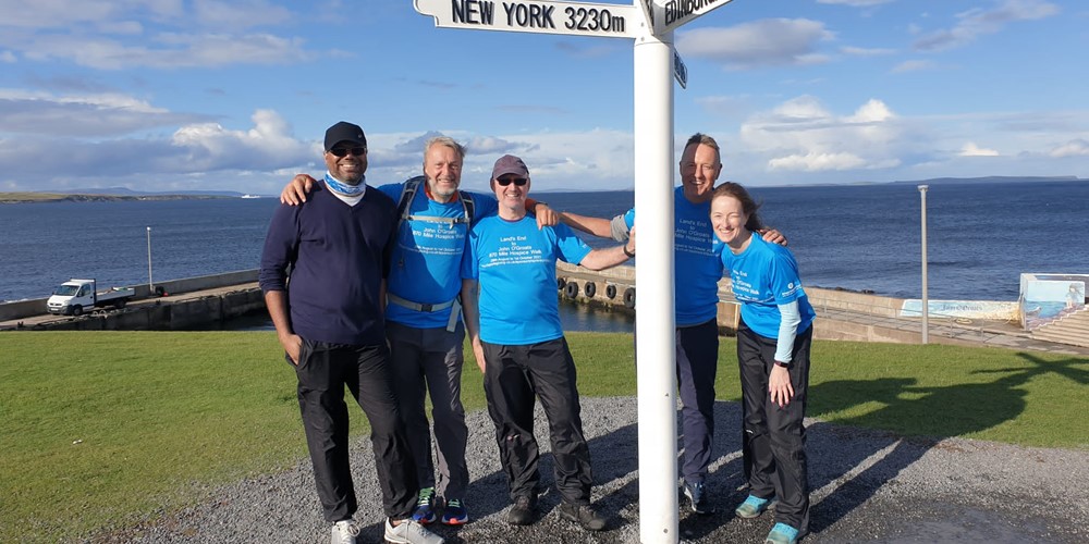 Image of 5 people at the John o'Groats sign
