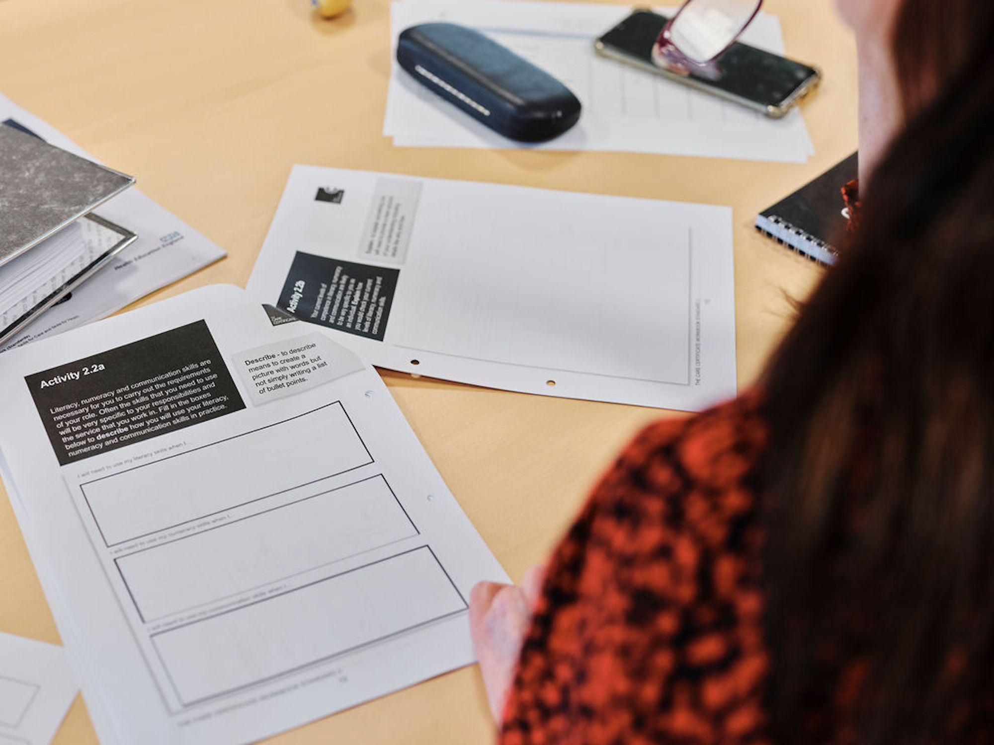 Image of woman taking notes in education course