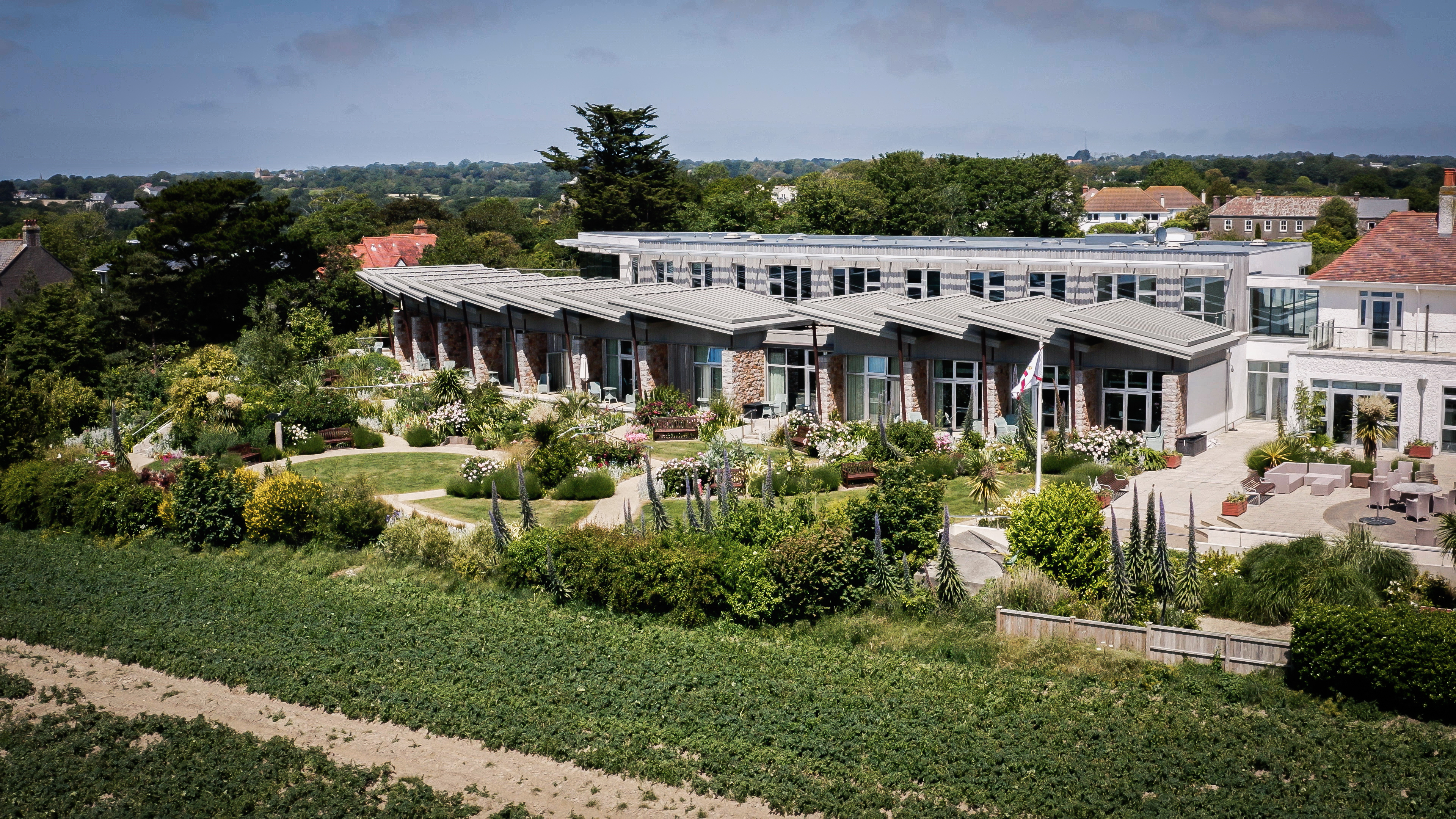image of aerial view of Jersey Hospice care building and gardens from nearby field