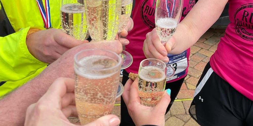 Image of runners cheersing with champagne after completing half marathon