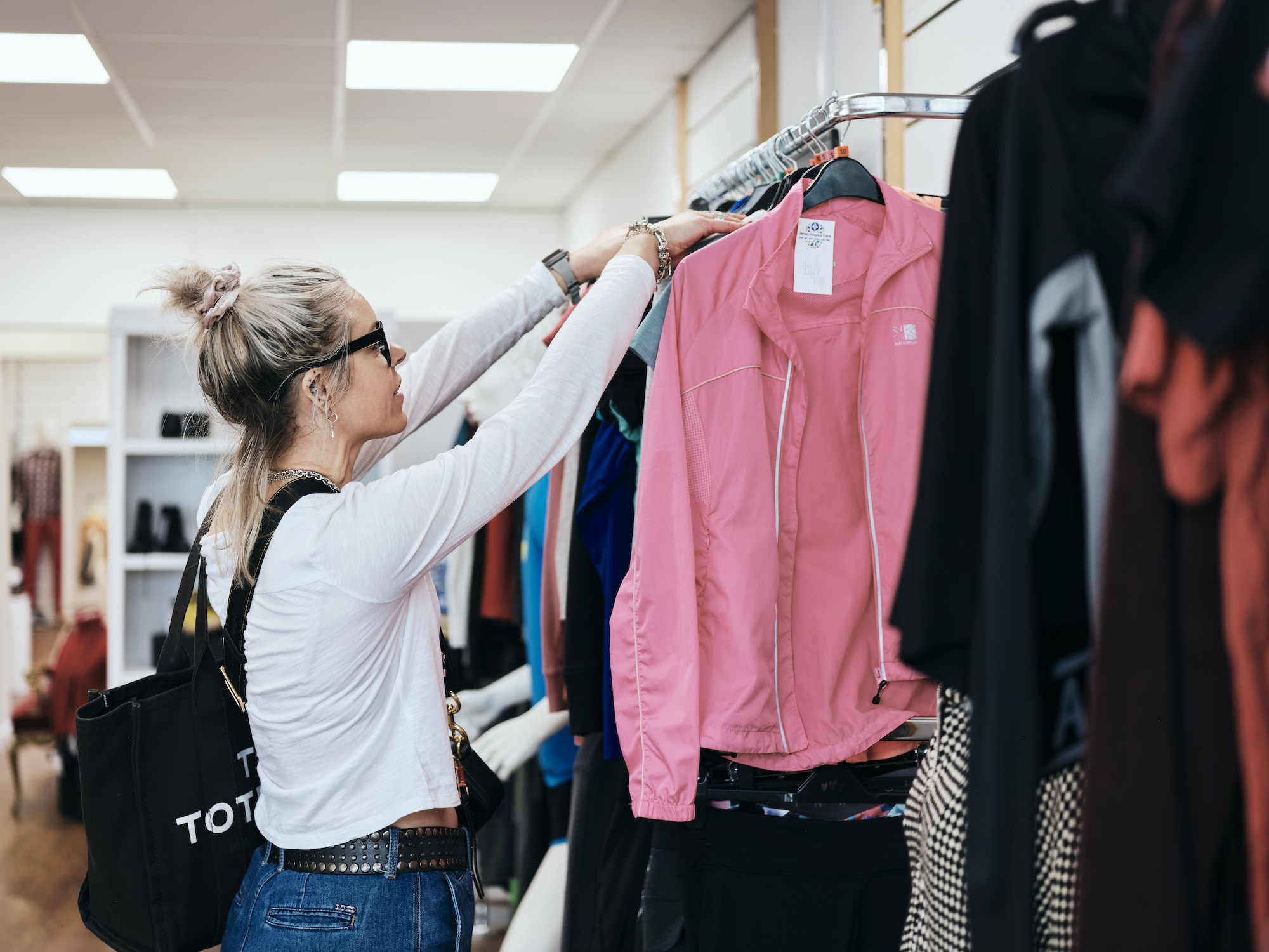 Image of customer brousing clothes in st helier fundraising store