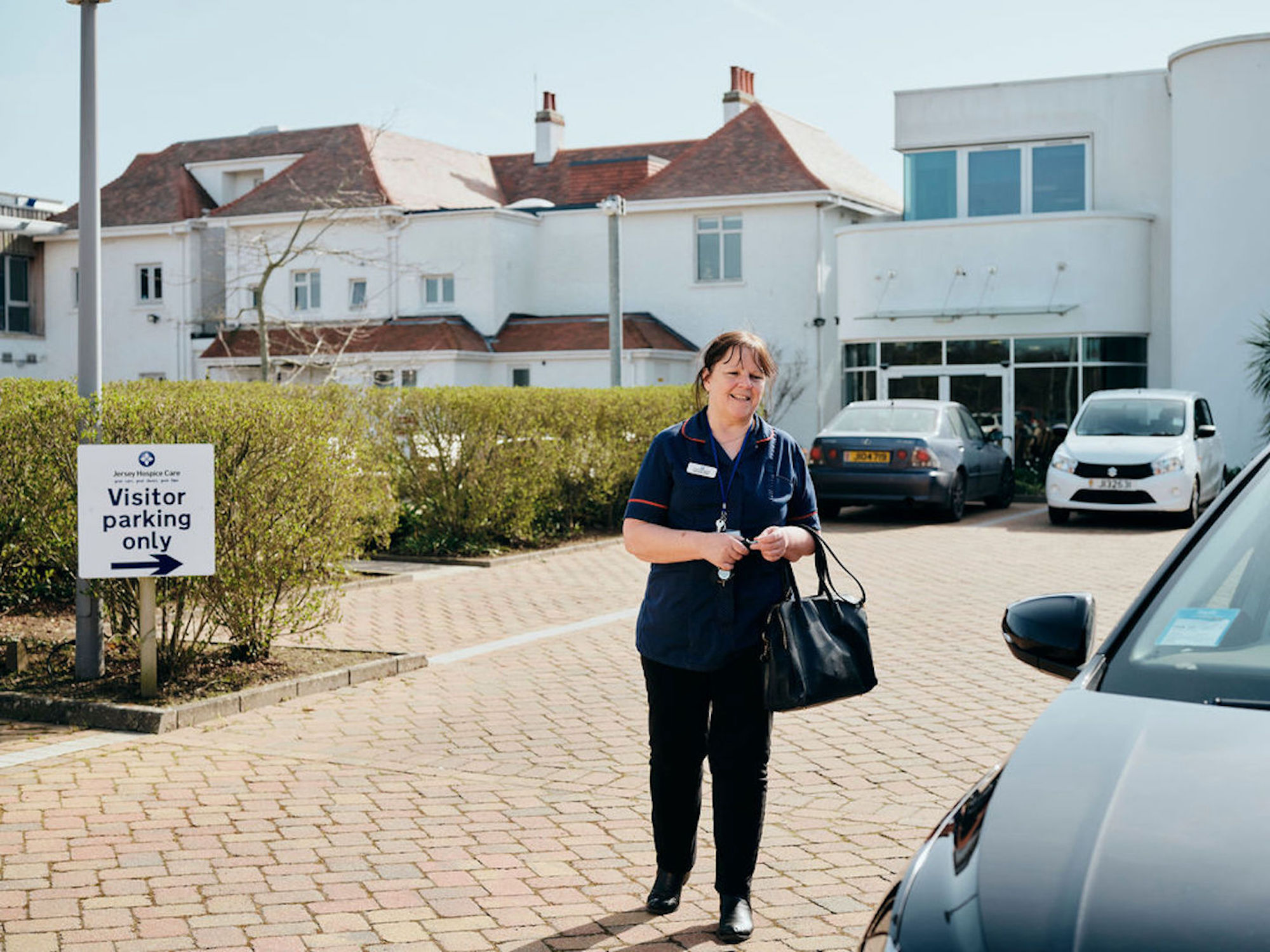 Image of community team nurse walking in car park at Jersey Hospice Care