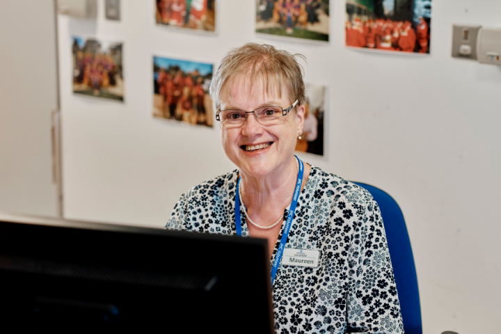 Image of admin volunteer at a computer at jersey hospice care
