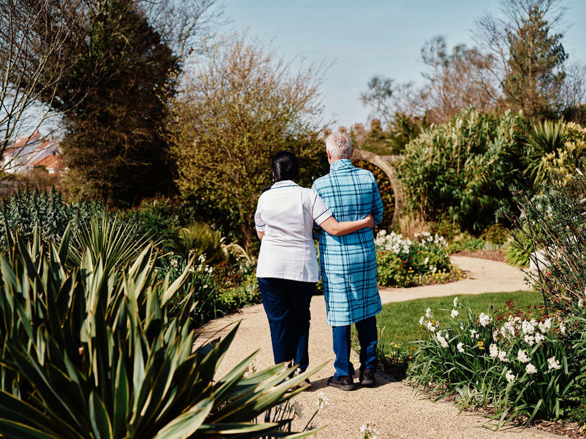 Image of nurse and patient walking in gardens at Jersey Hospice Care