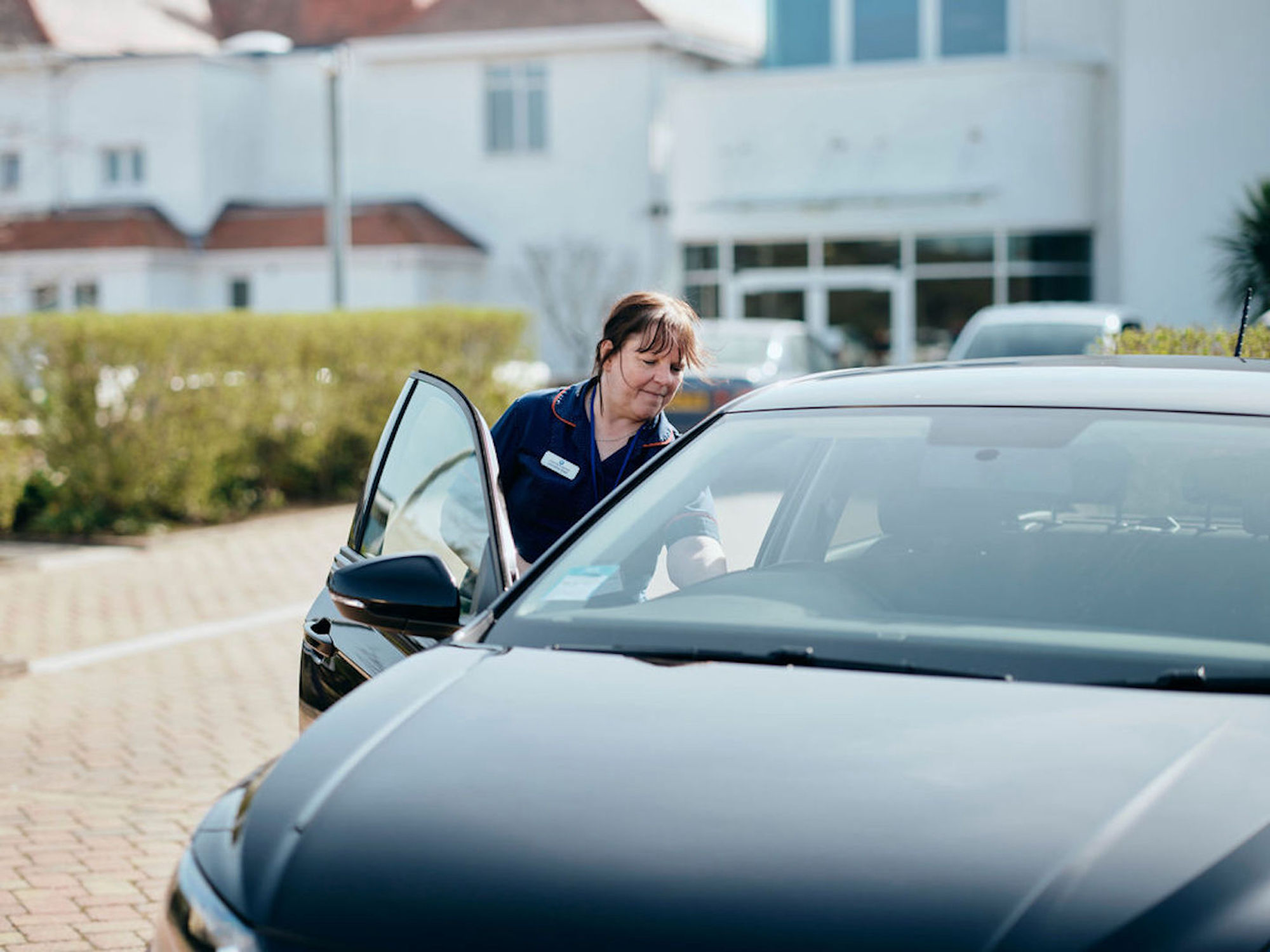 Image of nurse getting into her car