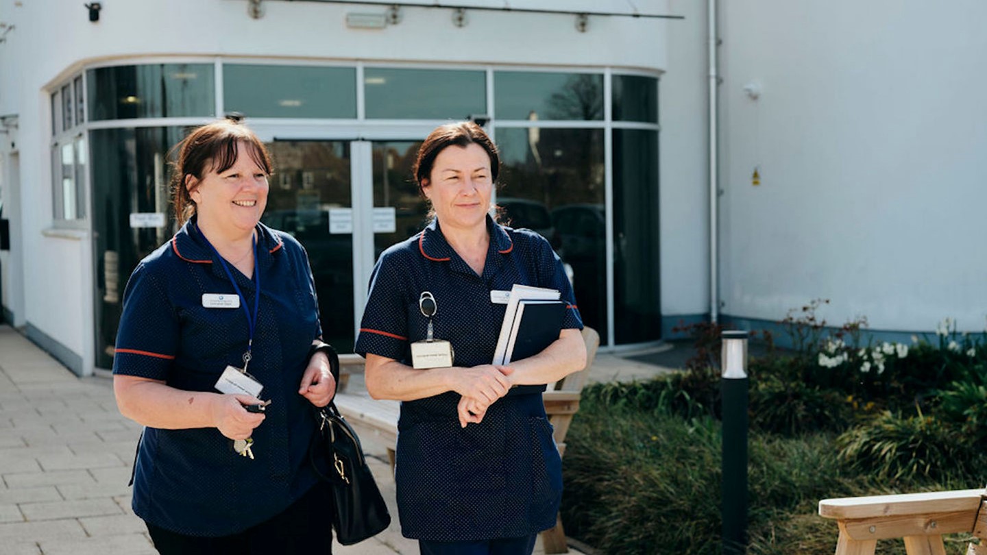 Image of Jersey Hospice Care nurses walking outside Hospice 